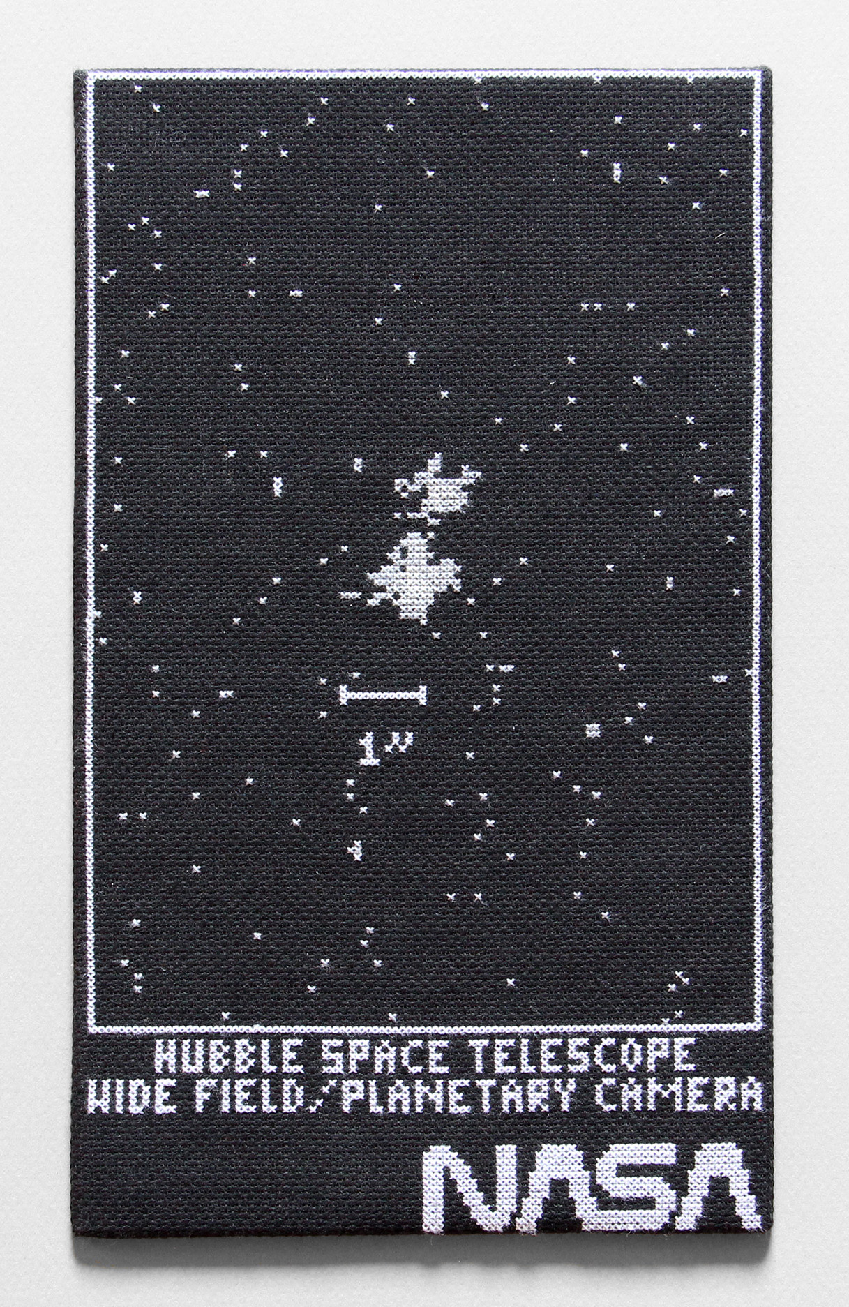  / Cross-stitch embroidery inspired by the first shot by Hubble. Art by artist Marine Beaufils.