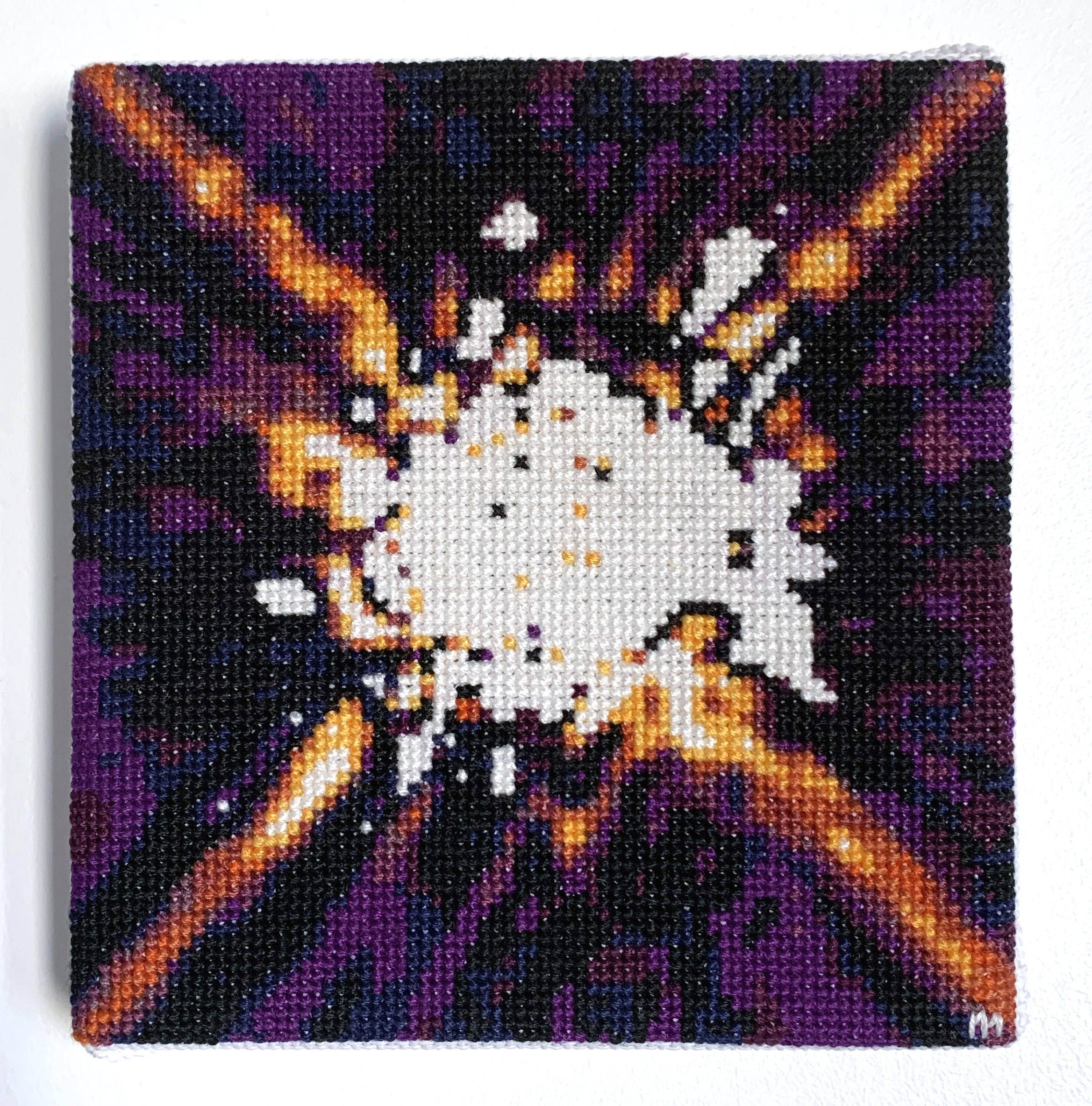  / Cross-stitch embroidery of the star HR 8799, inspired by an Hubble NICMOS shot. Art by artist Marine Beaufils.